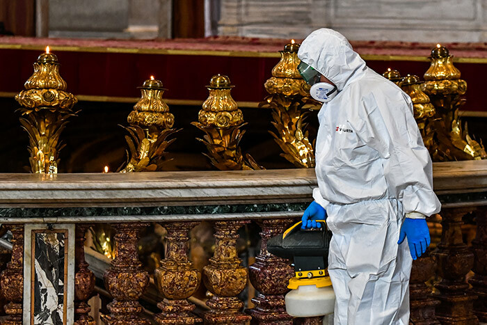   man wearing protective overalls and mask sprays sanitizer during the sanitation of t eters asilica in he atican on ay 15 2020 during the lockdown aimed at curbing the spread of the 19 infection caused by the novel coronavirus