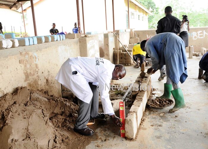  ackson osinghi the assessor assessing senior three student of ew orizon secondary and ocational schools in brick laying skills his was at during the implementation of   the dual curriculum in secondary schools 