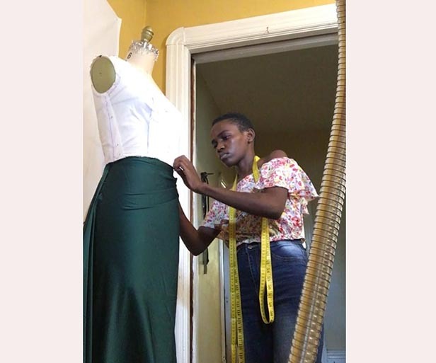  arah assali taking measurements of one of the clothes she had made ourtesy photo