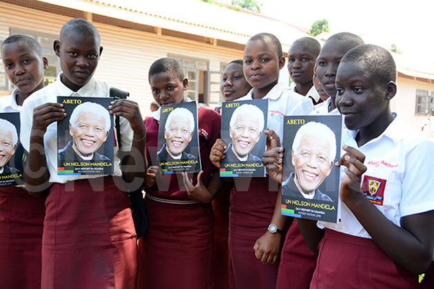  tudents of ololo econdary chool display copies of andela ook during the andela public lecture to commemorate the former resident of outh frica elson andela at the school campus hoto by rancis morut