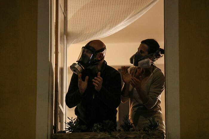 eople wearing a gas mask and an air filtering mask applaud at their window as part of a daily 8 oclock applause in support of medical workers in the rench iviera city of ice on arch 24 2020 on the eight day of a lockdown aimed at curbing the spread of the 19 novel coronavirus in rance hoto by