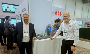 ABB's Francis Lacasse (left) and Wilson Monteiro next to a working model of a gearless mill drive, at MINExpo. Photo: Beth McLoughlin