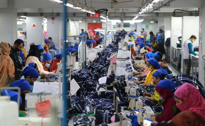  Women work at a ready-made garment factory in Dhaka, Bangladesh on Feb. 22, 2022. Image via Shutterstock/Rehman Asad