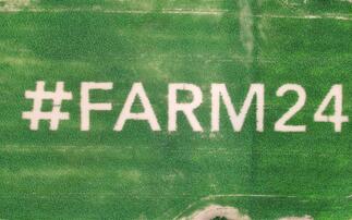 Giant #farm24 logo planted in field of maize 