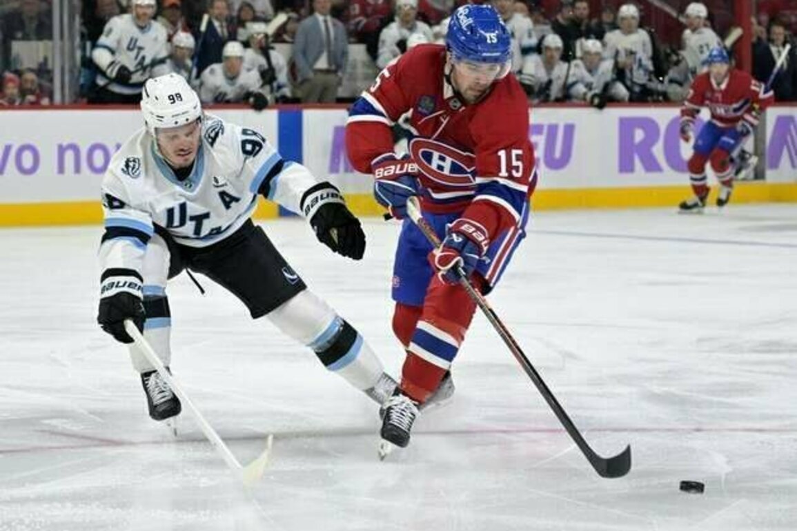 Canadiens F Alex Newhook helped off ice after collision with boards