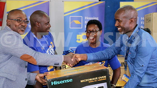   customer receiving a microwave oven that he won