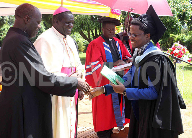  graduand shares a light moment with r r oseph serunjoji left after receiving his academic documents from ishop banyi in white cassock