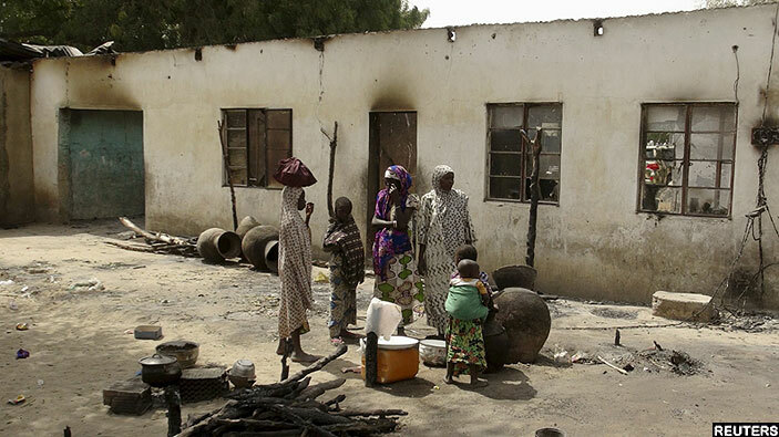  ictims of a oko aram attack on alori village stand with their possessions near damaged houses in aiduguri