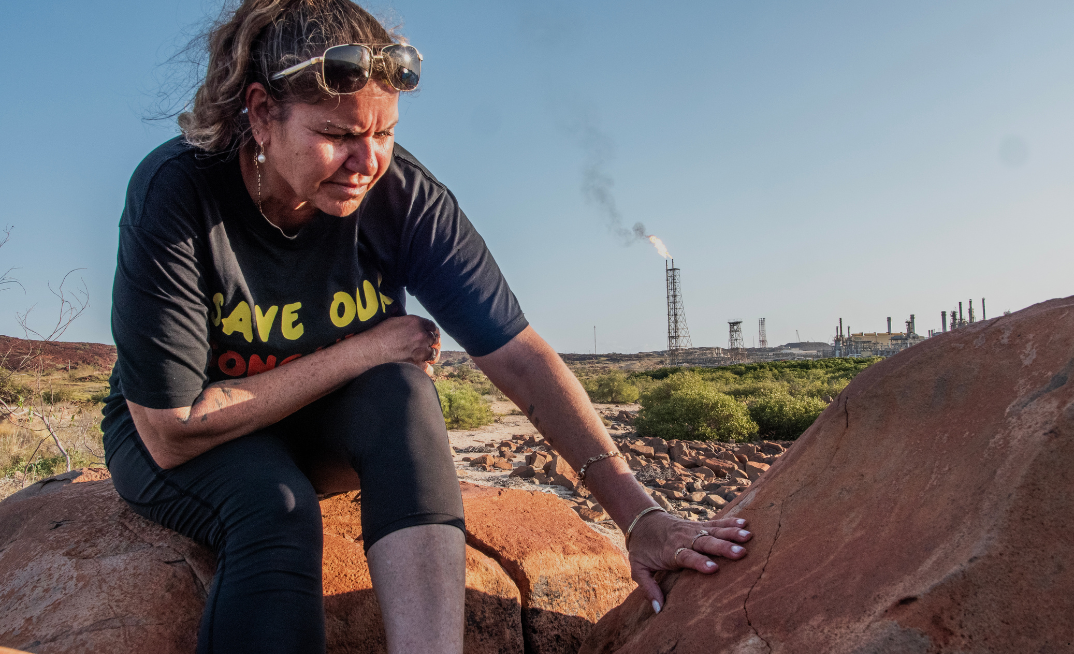 Raelene Cooper with a turtle petroglyph in front of North West Shelf