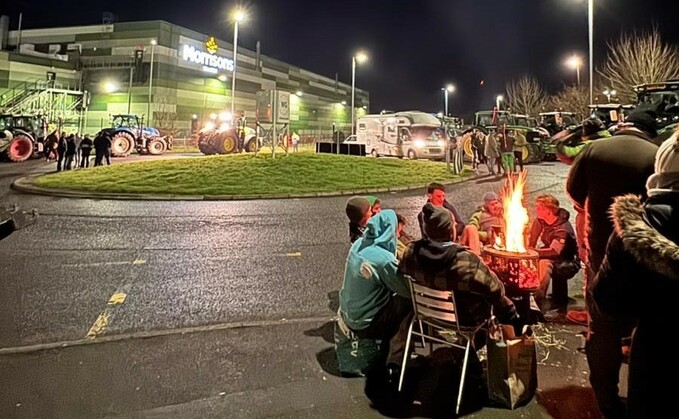 Protesters outside Morrison's Bridgwater distribution centre in Somerset last month. Law firm Pinsent Masons said the injunction granted by the court in this case does not prevent protesters from exercising their freedom of expression or freedom of assembly. Instead, it prevents obstructions to access points to distribution centres. (Farmers to Action)