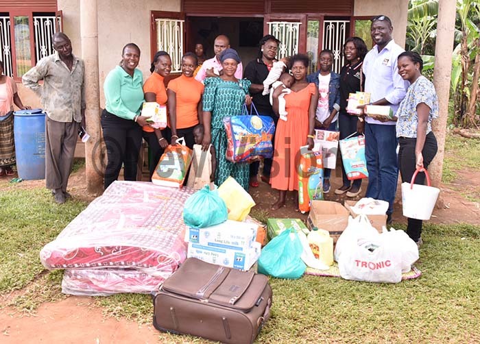  ane duba and ose kech in the centre with a team of parliament staff ew ision posing for a picture after the handover of the domestic items on ugust 16 2019 hoto by iriam amutebi 