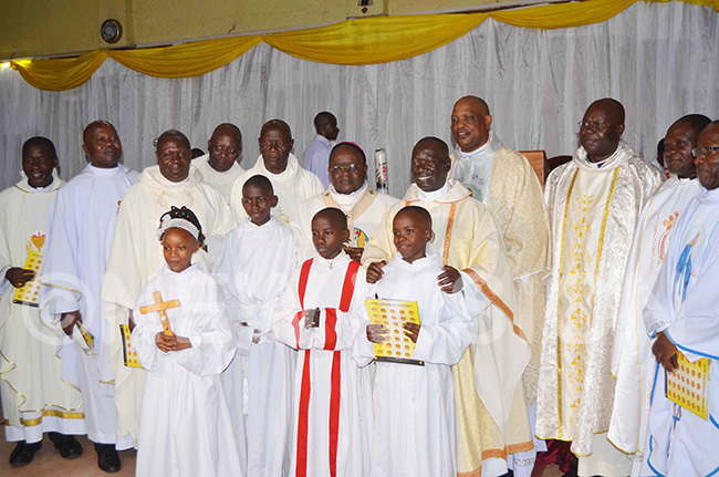  rchbishop wanga wearing a purple skullcap with r chilles ayanja and other priests from various dioceses during the event to celebrate r ayanjas 25 years in priesthood