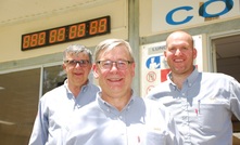 Dave Dicaire, Ron Hochstein and Mathieu Gignac (from left to right) standing before the project countdown clock