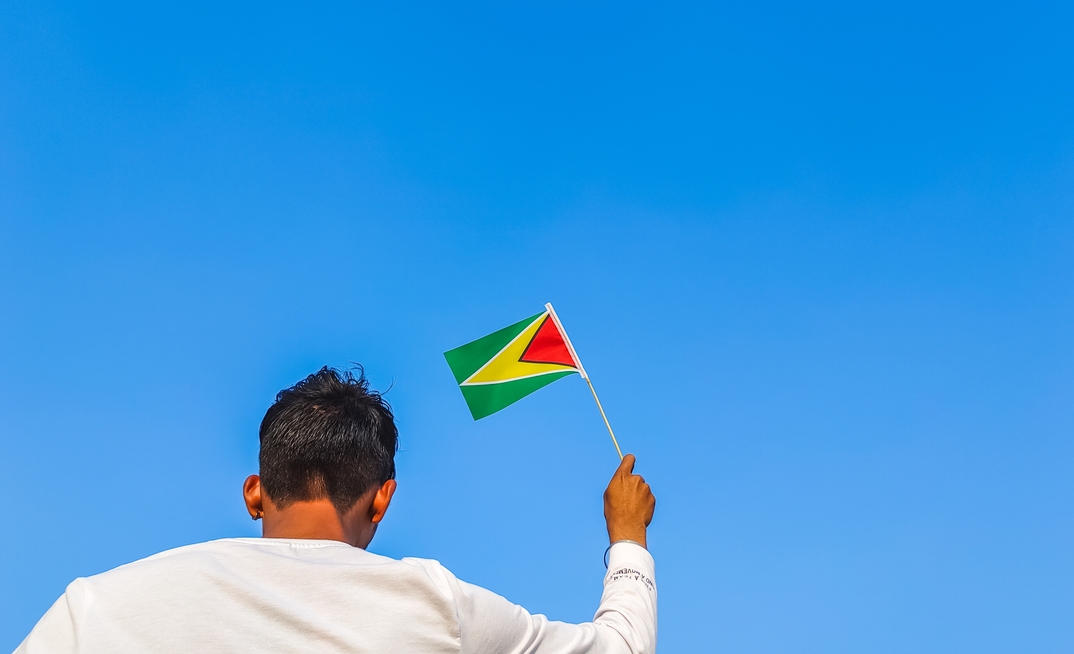 Boy holding Guyana flag