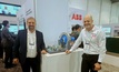 ABB's Francis Lacasse (left) and Wilson Monteiro next to a working model of a gearless mill drive, at MINExpo. Photo: Beth McLoughlin