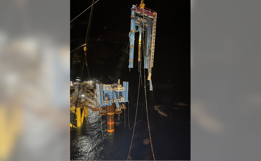 The broken off drilling rig dangles in the after the incident