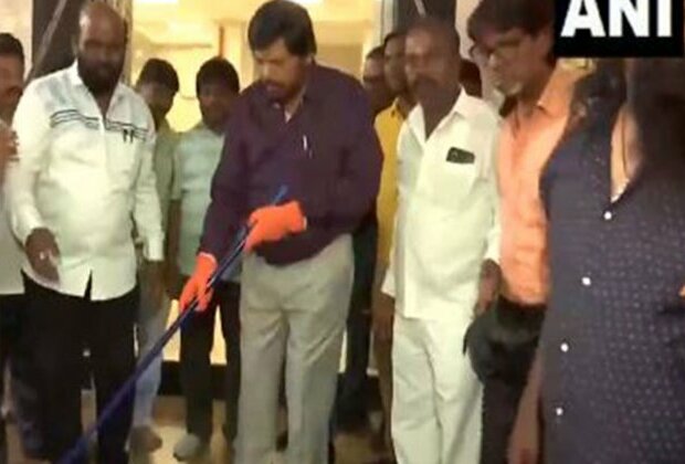 Union Minister Ramdas Athawale cleans the premises of Buddha Temple in Bandra area of Mumbai