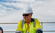 Workers on a Vicinity Centre rooftop installing solar technology