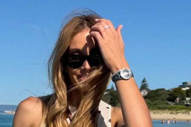 Bec Judd shows off her 'baby bump' in a spotted mini dress during her summer getaway