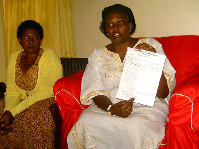  ugambwa eace displaying some of her  roups documents to the press