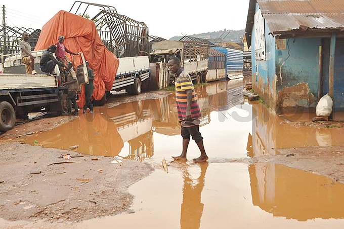 man wades his way through a flooded area in alukolongo hoto by onsiano simbi