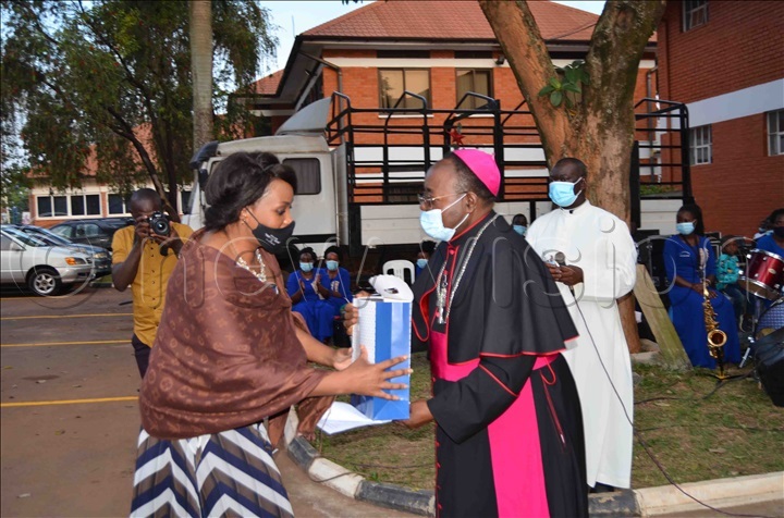 Archbishop Lwanga presenting a gift to Fiona Migadde