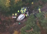 Cement lorry jack-knifes on to commuter train