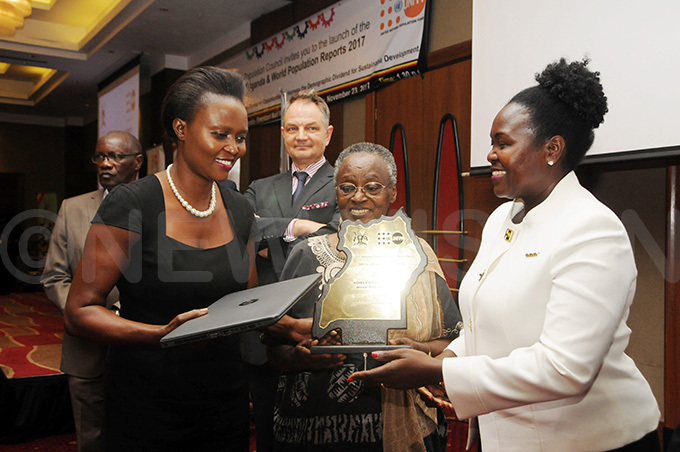  gnes yotalengerire ew ision features writer flanked by her grandmother etty utiisa middle receives her award ooking on is the  country representative lain ibenaler
