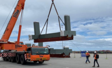 Shaft headframe sections being offloaded.