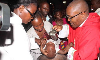 Faaza Emmanuel Kalema ng'abatiza omwana. Faaza Emmanuel Kalema ng'abatiza omwana.