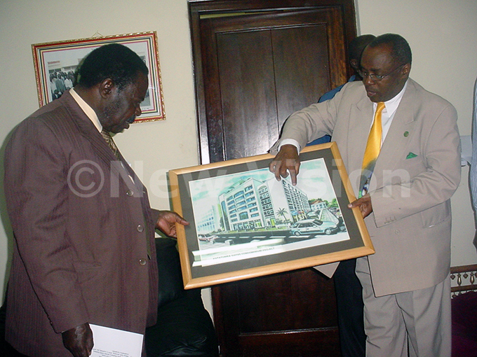atatumba showing the former ayor of ampala ohn sebaana izito a proposed plan of atatumba suites during a courtesy visit to the mayors office in ampala on uly 15 2005 