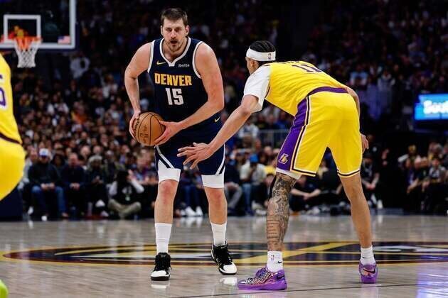 LeBron James sets record but exits injured in Lakers' loss to Nuggets