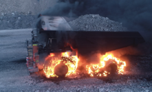  The truck in flames while driving on a haul road at a New South Wales open cut mine.