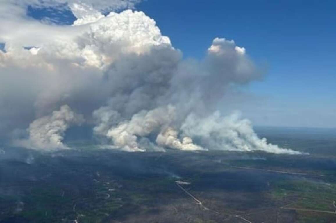 Firefighters temporarily trapped in northern Alberta as wildfires rage across the province