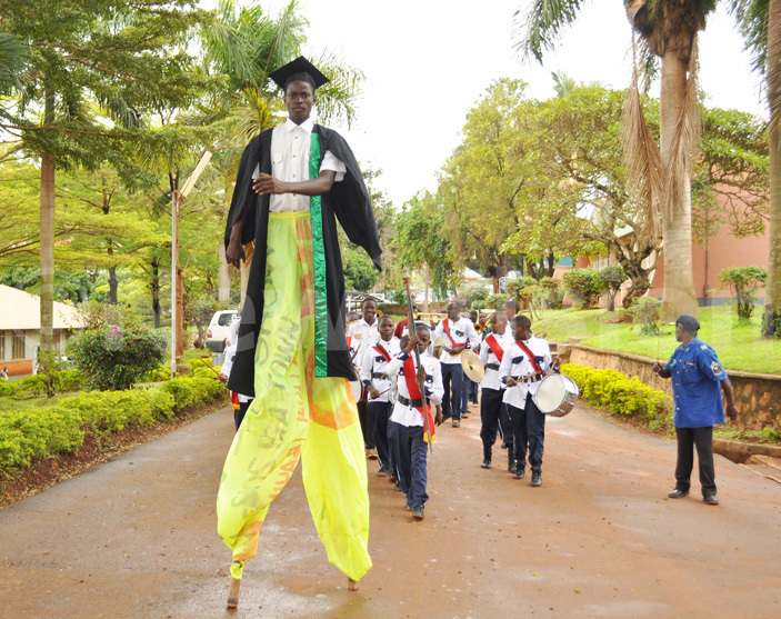   man using long sticks to walk entertaining guests during the graduation ceremony 