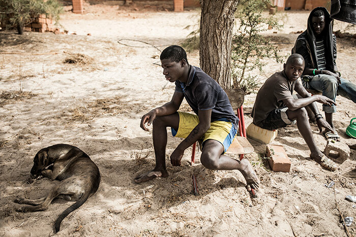  omeless young men are seen with their dog ion in a quarantined area at a refuge for newly arrived street children outside akar on pril 10 2020