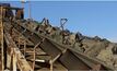 Ore on stockpile feed conveyor from shaft hoisting.