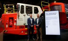 Mark Norwell (left) and Mats Eriksson with a Sandvik 63t diesel-electric underground haul truck at Minexpo. Credit: Perenti