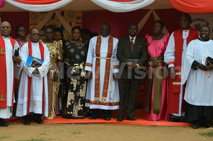  ugandas youth minister oses sekabembe in suit with the clergy after the service at usa ukasa hrine