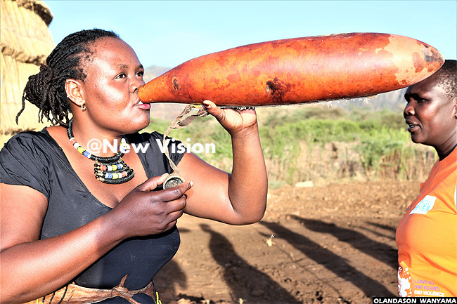   arimojong woman drinks water from a gourd at teker ultural entre