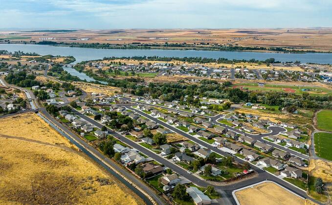 At the confluence of the Umatilla and Columbia rivers in eastern Oregon, water winds through the town of Umatilla's neighborhoods. An irrigation canal is fed by cleansed cooling water straight from a nearby AWS data centre. The water is used to grow the corn, soybeans, and wheat for which the region is famous / Credit: Amazon/Noah Berger