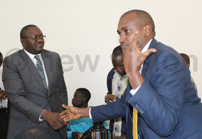 ncoming permanent secretary incent aiswa agiire  is congratulated by umwebaze during the ceremony hoto by ancy anyonga