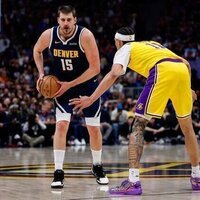 LeBron James sets record but exits injured in Lakers' loss to Nuggets