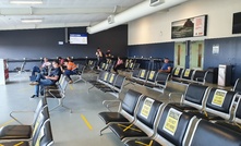 Moranbah workers social distancing at the airport.