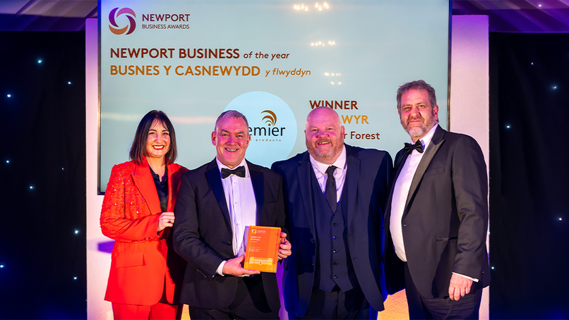 Lucy Owen, Dave Timson, Kevin Ward, and Lyndon Edwards collecting the Business of the Year Award.