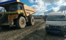  The haul truck collided with van after reversing away from a railway crossing. 