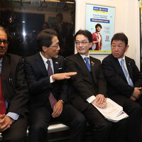 Japanese Foreign Minister Toshimitsu Motegi takes a ride on Delhi Metro