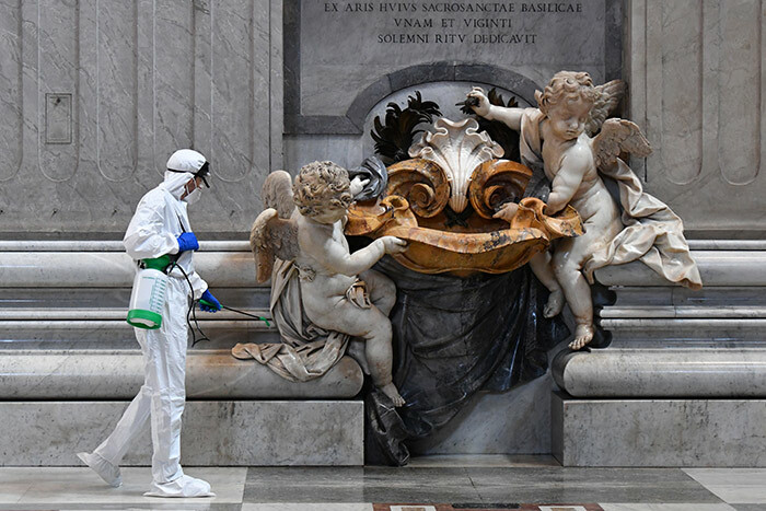   man wearing protective overalls and mask sprays sanitizer during the sanitation of t eters asilica in he atican on ay 15 2020 during the lockdown aimed at curbing the spread of the 19 infection caused by the novel coronavirus hoto by lberto   