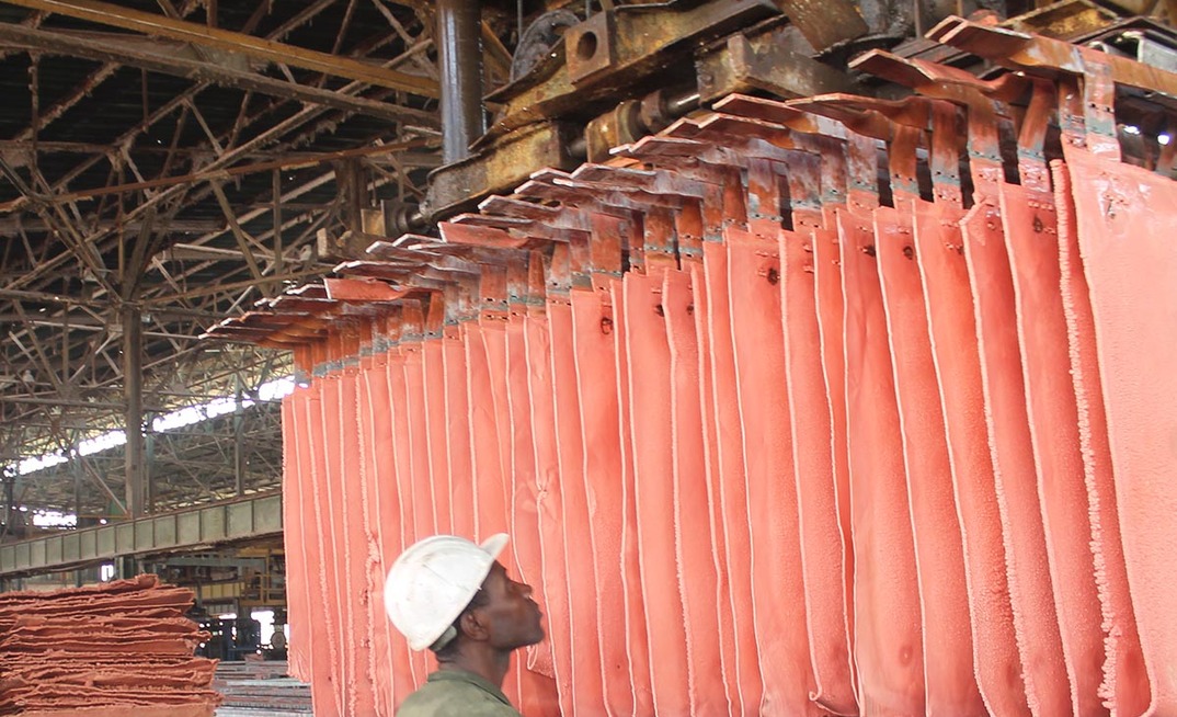 A worker handles copper plates at a Gecamines operation. Photo: Gecamines