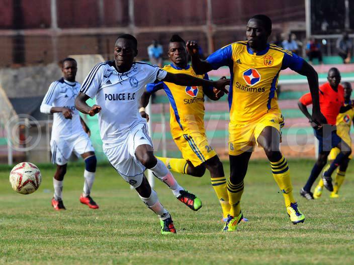  olice striker onald yanzi shields the ball from s ulaiman kinyemi and akim enkumba